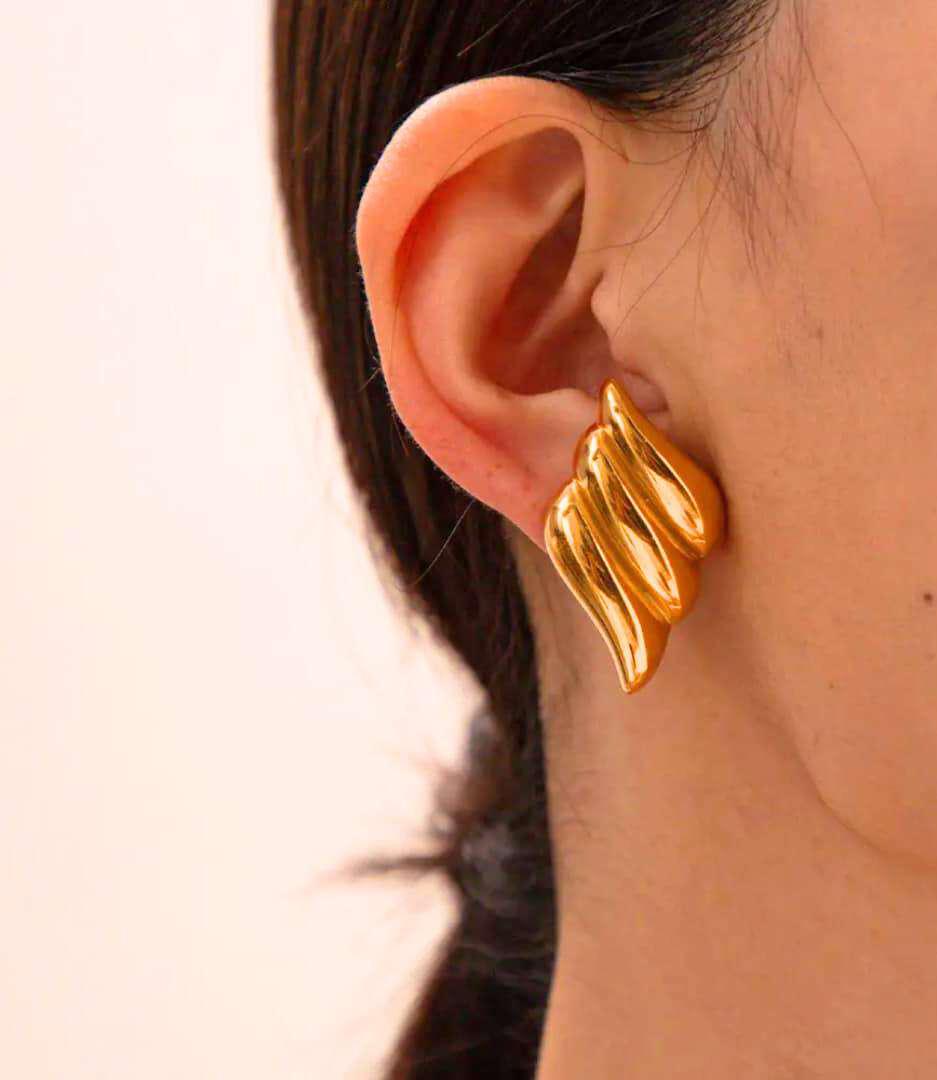 Leaf Stud Earrings β Elegant Gold Nature Inspired Jewelry on model Gold leaf stud earrings with textured nature-inspired design on model