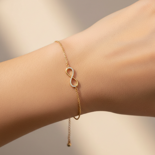 Infinity Crystal Bracelet on model hand – Bougee Jewels Infinity crystal charm bracelet with golden finish on model hand by Bougee Jewels