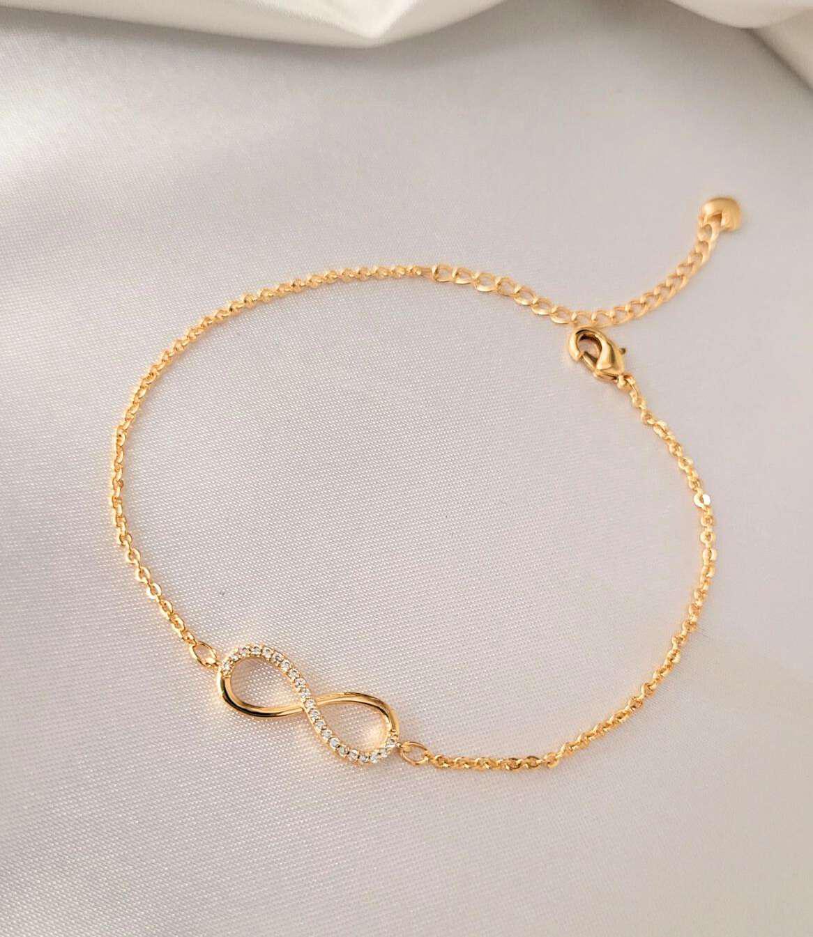 Infinity Crystal Bracelet – Bougee Jewels Infinity crystal charm bracelet with golden finish by Bougee Jewels