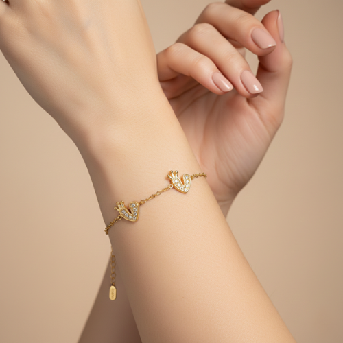 royal heart bracelet on model Royal heart charm bracelet with crystal detailing in golden finish by Bougee Jewels